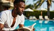 © ILIUSIA - Man reading a book by the pool on a sunny day
