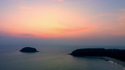 Wall Mural - Aerial view of pink sky above the island 
The hyperlapse view captures the beauty of the pink sky as it slowly changes from a light pink to a deep, vibrant hue.
sweet sky background.