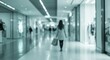 © Muaz - Woman walking away in a mall hallway with shopping bags in a blurred teal toned environment view