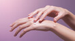 © daisy * - Close-Up Hand Gesture Applying Skincare Lotion on Hand – Minimal Beauty Shot