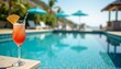 © Tanyastock - Refreshing cocktail with orange by sunny pool.