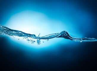 Leinwandbilder - A close-up view shows a blue liquid surface, possibly water, with motion, light, and fluidity. It suggests a fresh, clean, and natural environment. The image highlights an abstract view of a wave.