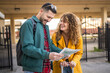 © Miljan Živković - adult couple use map for navigation and explore on the train station
