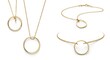 © Firman Dasmir - Elegant golden circle pendants showcased against a pristine white backdrop