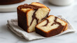 © focuslyimg.com - Delicious marble cake sliced and served on a linen napkin in a cozy kitchen environment