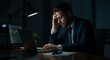 © shadab - A weary businessman, burdened by late-night work and financial anxieties, sits alone in dim office lighting, illuminated only by a desk lamp casting shadows.