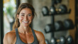 © Artem Zatsepilin - workout poster or ad, bodybuilding. smiling sporty caucasian woman in gym with weights in background. fitness and health concept. promoting active healthy lifestyle and personal training.