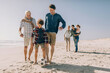 © Marko Geber - Multigenerational family playing soccer and having fun on a sandy beach on their vacation