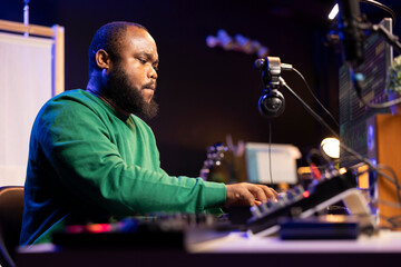 Poster - Songwriter mixing and mastering tracks on stereo console, playing electronic keyboard in home studio. Artist oversees audio performances to ensure the perfect melody, producing tunes with piano keys.