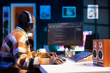 male programmer working on developing new html script, typing binary code on terminal window. young 