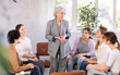 © JackF - Friendly and calm senior female psychotherapist or facilitator leading group therapy session with women of different ages sitting on chairs in circle