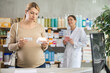 © JackF - Pregnant woman choosing box of pills with help of young female pharmacist in pharmacy