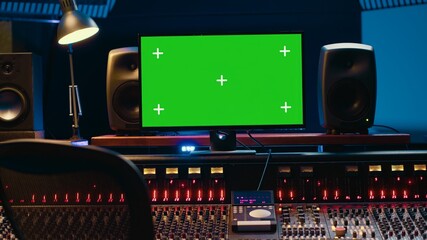 Leinwandbilder - Control room with greenscreen running on computer next to buttons and sliders, multiple controls and switchers on panel board mixing console. Empty professional studio with stereo gear. Camera A.