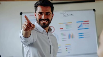 Poster - A smiling man presents with confidence in a modern office setting, pointing towards his audience. Charts and a clock adorn the whiteboard, adding a layer of visual information to the discussion.