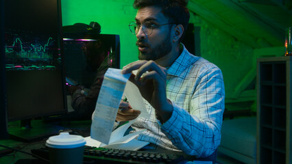 Arabian Indian man male guy programmer examining writing binary code coder freelancer engineer worker IT specialist monitor analyzing computer ecommerce office business hacker businessman Bitcoin web