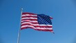 © WutStock01 - A vibrant, large American flag billows majestically against a clear blue sky, its red and white stripes and bright stars vividly contrasting with the backdrop, symbolizing patriotism and freedom.