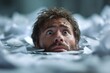 © grey - Close up of the face of a suffocating male employee trying to catch a breath from the sea of documents that flooding him