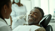 © Karina Korytchenko - Middle-aged African-American man smiling during dental checkup in a bright, modern clinic with healthcare professionals nearby