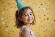 © Indraa - A joyful young girl happily celebrating her birthday over isolated colorful background in a birthday party Generated by Ai