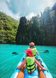 © EVERST - Family summer vacations kayaking in Philippines travel healthy lifestyle active trip, parents and child exploring Palawan island turquoise water lagoon tropical vibes