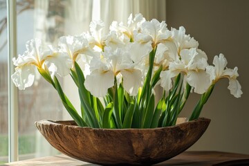 Poster - Vibrant white irises arranged in a rustic wooden bowl near a sunlit window on a warm afternoon