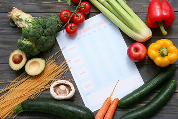 Wall Mural - Healthy products and weekly meal plan on wooden background. Diet concept