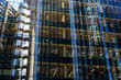 © yaqui_villegas - Glass curtain walls of office towers with warm interior lighting, suggesting activity, enterprise and collaboration.