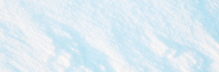 Wall Mural - wide panoramic winter background with snowy ground. natural snow texture. wind sculpted patterns on 