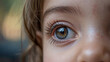 © Анастасия Астанина - Close-up of a child's eye revealing intricate details and reflections, showcasing curiosity and innocence during a sunny day