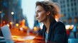 © NovaVision - A thoughtful businesswoman looks off into the distance, with a laptop nearby, set in a blurred urban environment with warm, bright lights.