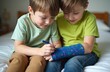 © miss irine - Two young brothers draw on broken hand cast. Supportive sibling helps, cheers up boy with injury. Home, family, love, care, childhood, accident, medical theme. Friendship.