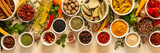 Variety of vibrant spices and dried herbs arranged on a beige backdrop, essential for culinary seasoning and enriching dishes with aromatic, natural flavors, banner