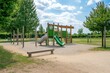 © senyumanmu - Outdoor playground features slides, climbing frames, and a wooden bench
