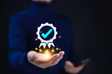 Poster - Certified Quality Assurance and Certification Compliance Concept. A person holds a glowing certification icon with checkmark and five gold stars, symbolizing trust, quality assurance, and compliance.