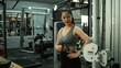 © saltdium - A Sporty Woman Exercising Rotator Cuff with Cable Machine for Shoulder Health