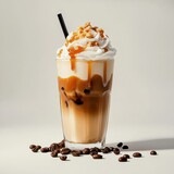 Iced caramel macchiato with whipped cream swirl and drizzle in tall clear glass, isolated on white background