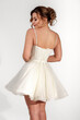 © Svetlana - Model poses in elegant white dress with a flared skirt showcasing a stylish back detail in a studio setting