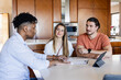 © Wavebreak Media - African american realtor with couple, signing lease, at home