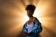 © Wavebreak Media - African American woman in blue jacket posing confidently with dramatic lighting