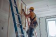 © Vorda Berge - Construction worker installing house wall insulation in new home