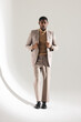 © Wavebreak Media - Confident man in stylish suit posing in studio, showcasing modern fashion