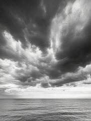 Poster - Dramatic black and white clouds dominate the horizon over a serene minimalist sky landscape