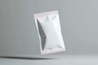 © Shahida - Closeup of Floating White Glossy Sachet on a Gray Background with Subtle Shadowing