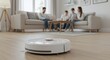 © GS-Studio - A futuristic smart robot vacuum cleaner is diligently cleaning the hardwood floor. Meanwhile, in the blurred background, a family of four is relaxing on the couch