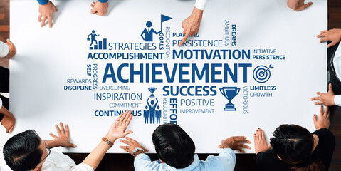 Leinwandbilder - A dynamic team collaborates over a table showcasing key motivational concepts related to achievement, success, and personal growth through visual graphics and keywords. Amity