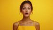 © Oleksandr - Portrait of surprised young woman opening her mouth on yellow background