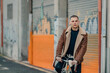 © carballo - fashionable young man with bicycle in urban background with copy space
