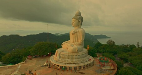 Wall Mural - aerial view bright yellow sun in sunrise at Phuket big Buddha. the sun breaks through the clouds and illuminates the Buddha statue that atop the mountain.
Sunrise with amazing light rays effects.
