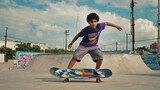 A young man rides a skateboard at a skate park, performing tricks and having fun