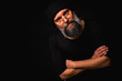 © Jurii - Angry bearded man in black beanie and glasses snarling at the camera. Dramatic portrait in low key lighting, expressive face, emotional tension, dark background
